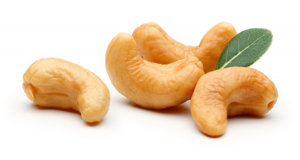 A close up of some cashews on a white surface